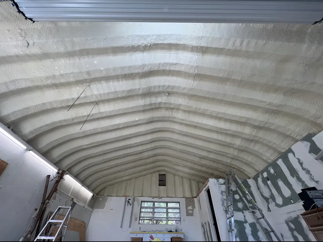Spray polyurethane foam applied to the underside of a metal roof deck in Southside
